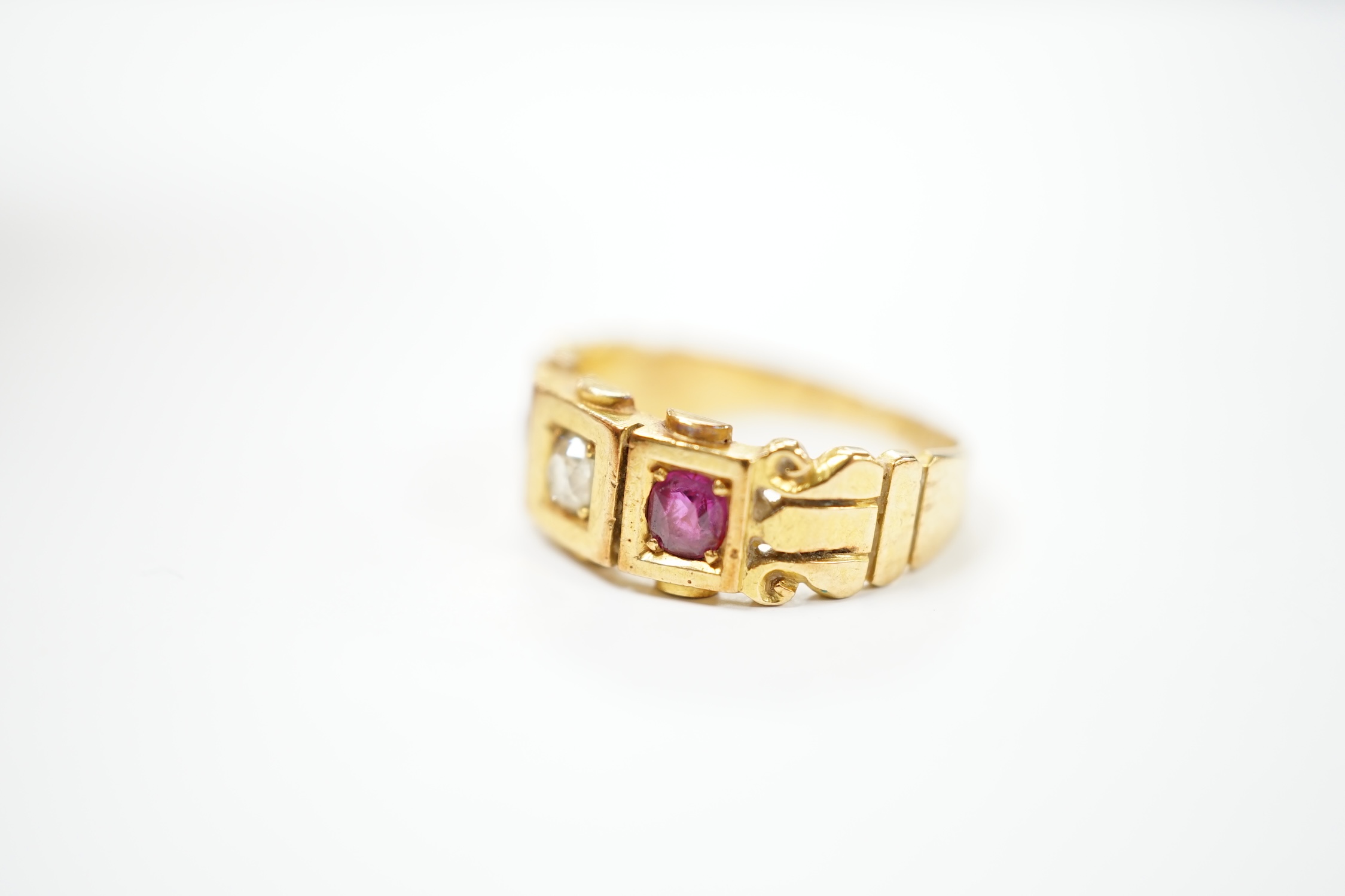 A late Victorian 18ct gold, ruby and diamond set three stone ring, size J, gross weight 4 grams. Condition - fair